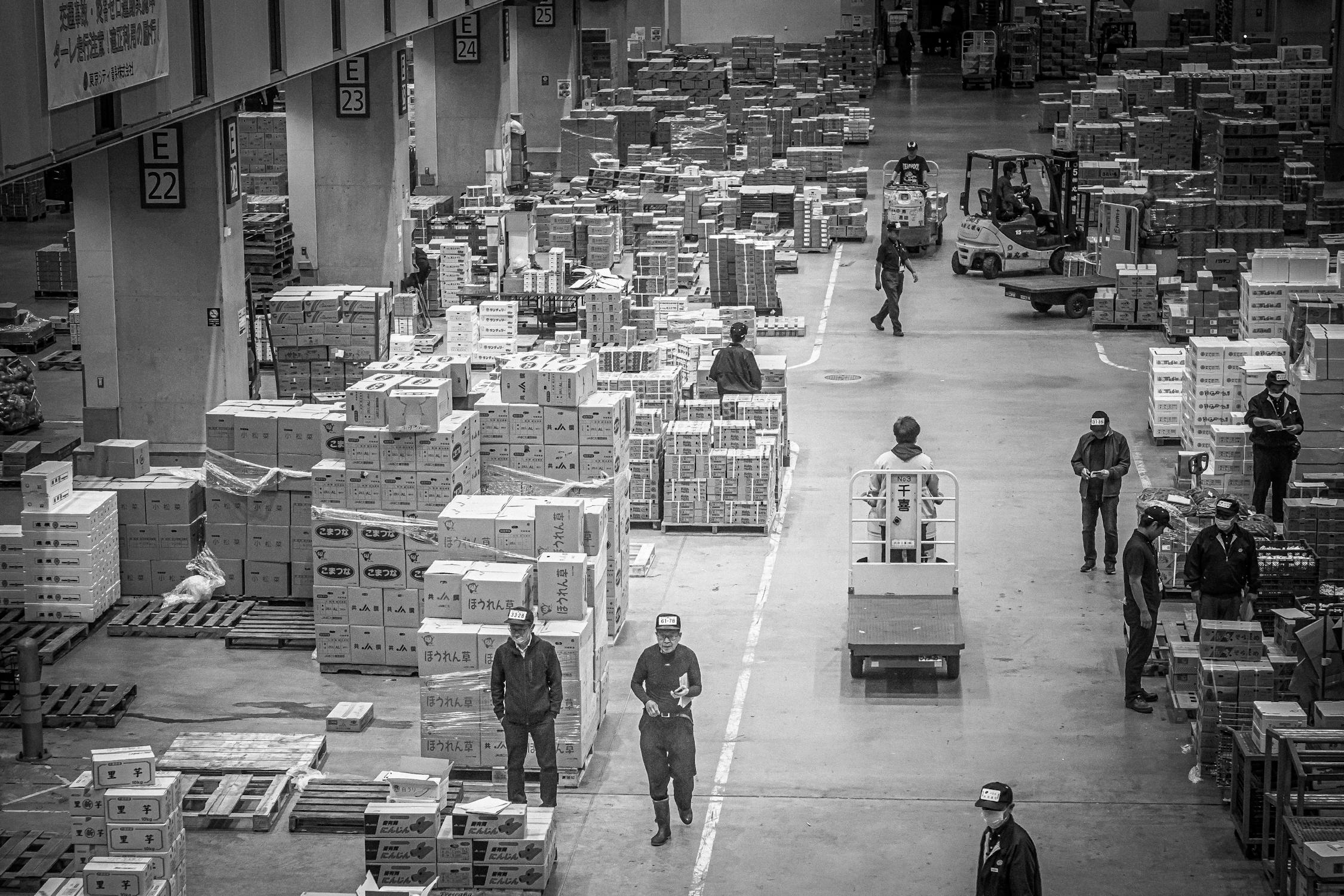 Workers organizing packages in a Japanese warehouse - logistics and distribution sector employs many foreign residents