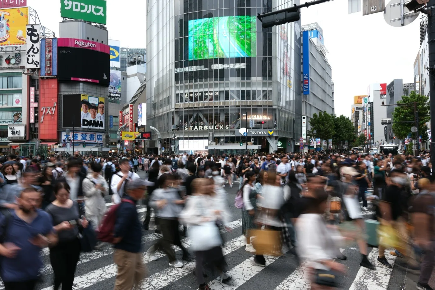 Crowds crossing a busy Tokyo intersection by day, reflecting Japan's increasingly diverse society
